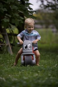 Portrait of boy playing with toy on field