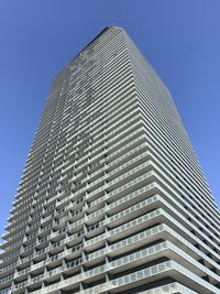 Low angle view of modern building against clear blue sky