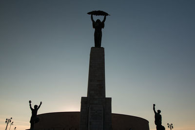 Low angle view of statue against sky