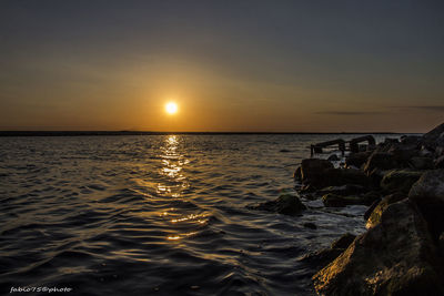 Scenic view of sea against sky at sunset