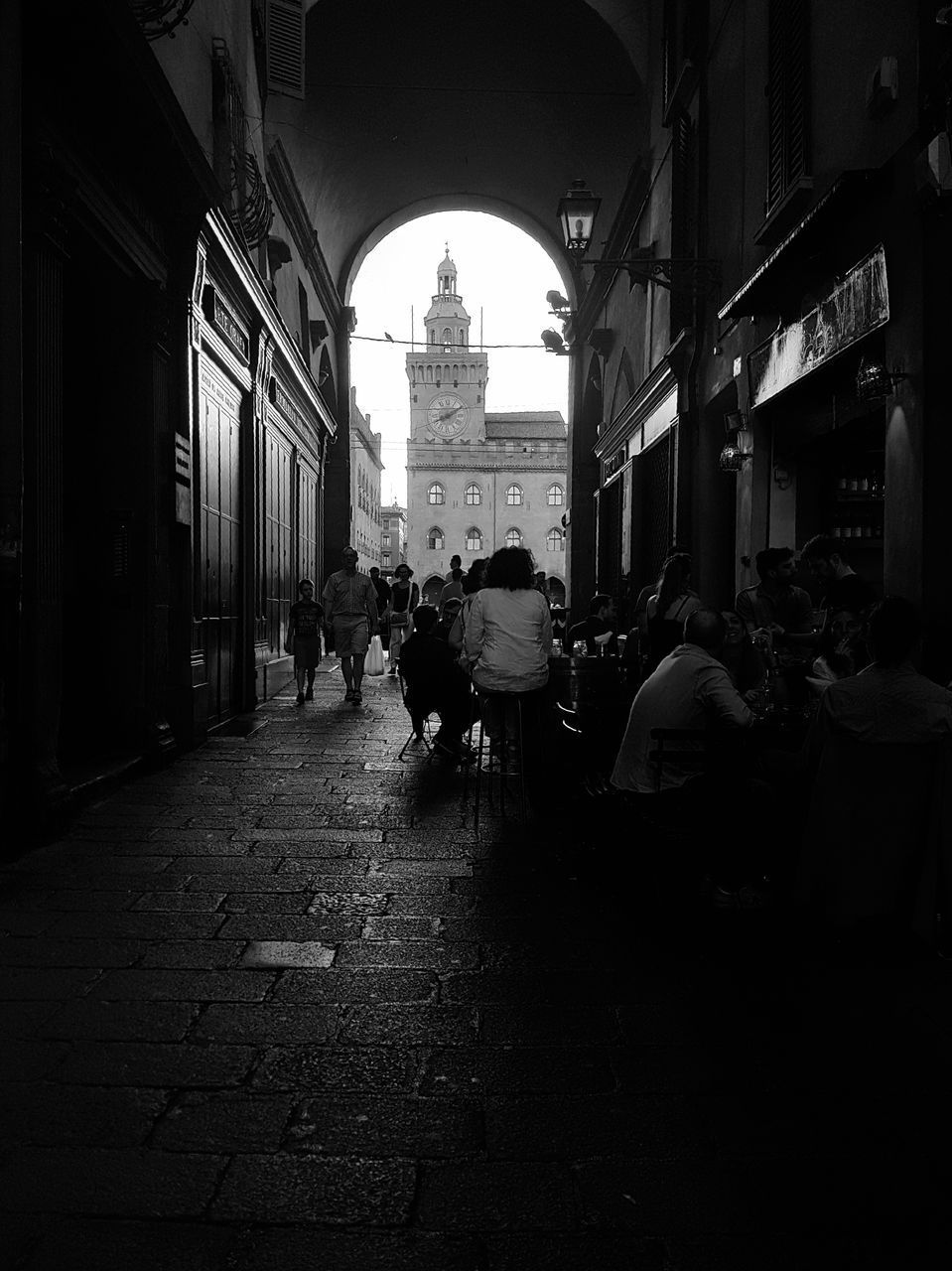 PEOPLE WALKING ON STREET IN CITY BUILDINGS