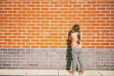 Person standing on brick wall