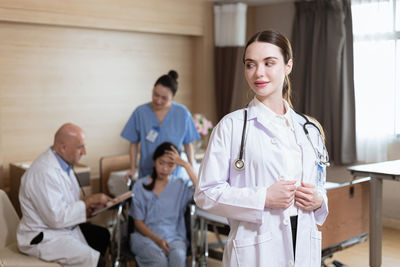 Portrait of female doctor examining x-ray at clinic