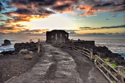 Pier on sea at sunset