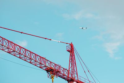 Low angle view of crane against clear sky