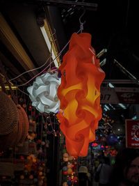 Low angle view of illuminated lanterns hanging at market stall