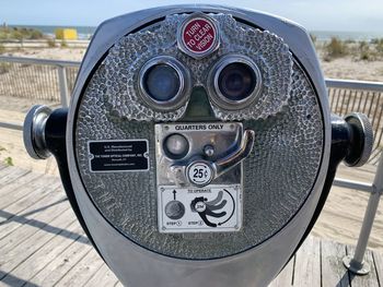 Close-up of coin-operated binoculars against sky