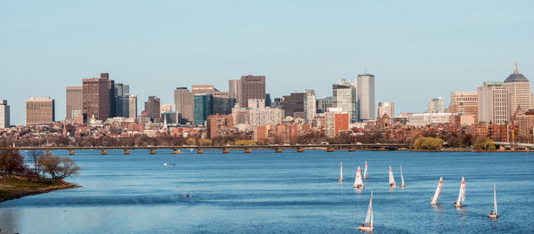 Sea and buildings against clear sky