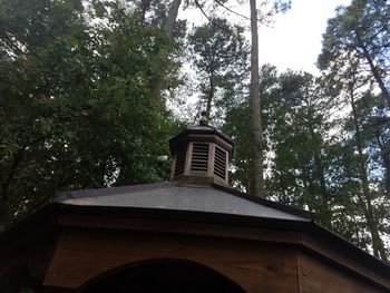 Low angle view of built structure against trees