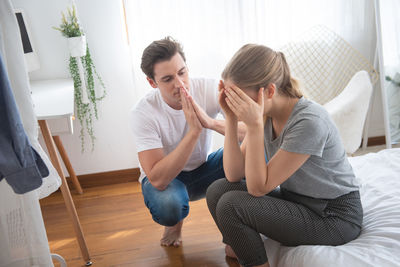 Friends sitting on floor at home