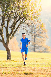 Full length of man running on field