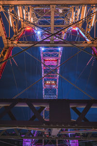 Illuminated ferris wheel at night