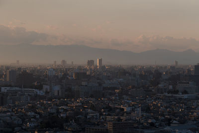 High angle view of city buildings against sky during sunset