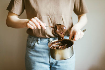 Midsection of woman holding ice cream