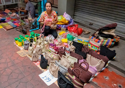 Midsection of woman sitting at market stall