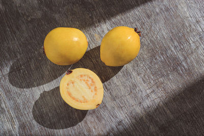 Yellow guava on wooden background. vitamin c, healthy fruit diet.