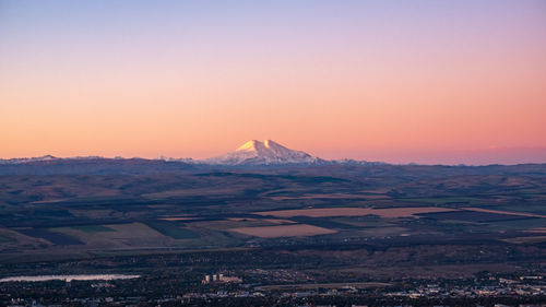 Scenic view of landscape against clear sky during sunset