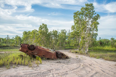 Abandoned truck on field against sky