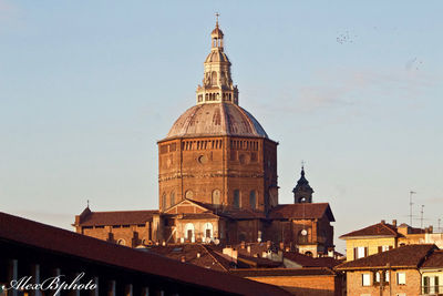 Church in city against sky