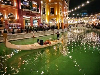 People in illuminated city at night