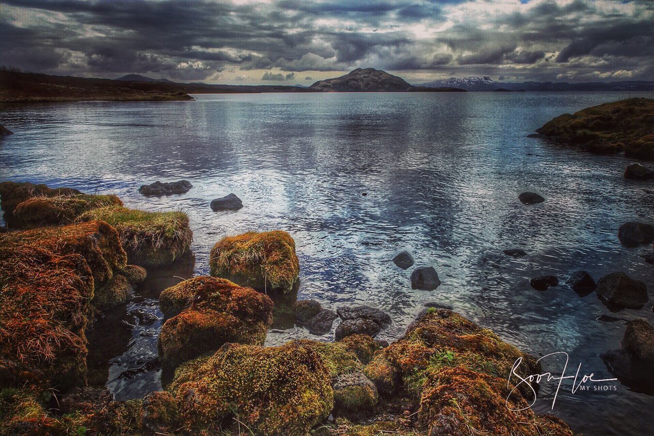 ROCKS ON BEACH AGAINST SKY