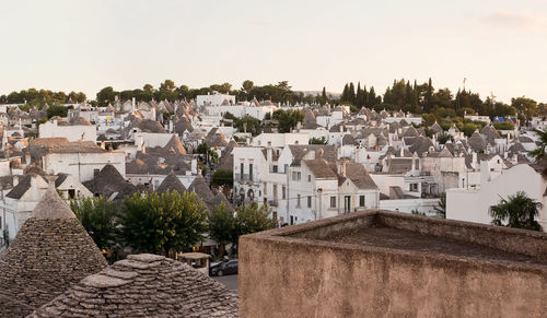 High angle view of houses in town against clear sky