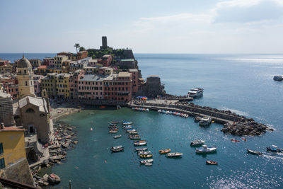 High angle view of city by sea against sky