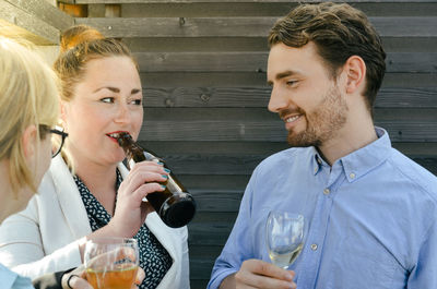 Portrait of a smiling young business people drinking