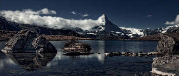 Scenic view of snowcapped mountains against sky