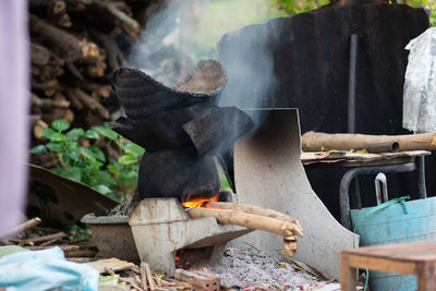 High angle view of bonfire on wooden log