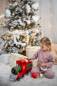 Portrait of boy playing christmas tree