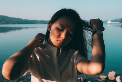 Portrait of young woman by lake