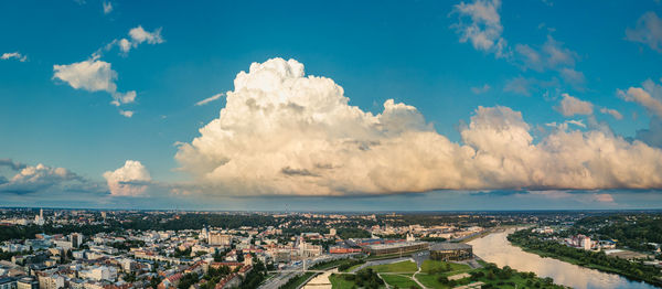 Panoramic view of cityscape against cloudy sky