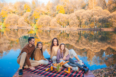 Family sitting by lake