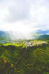 Scenic view of city against cloudy sky