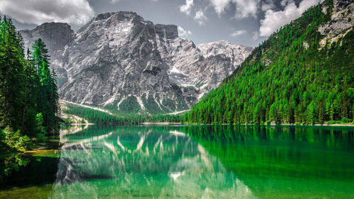 Scenic view of lake pragser wildsee and mountains against sky