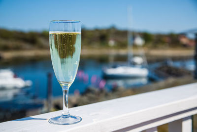 Close-up of wine in glass on railing