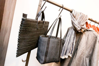Close-up of clothes drying on clothesline against wall