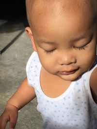 Close-up of cute baby boy standing on footpath