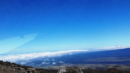 Scenic view of mountains against blue sky