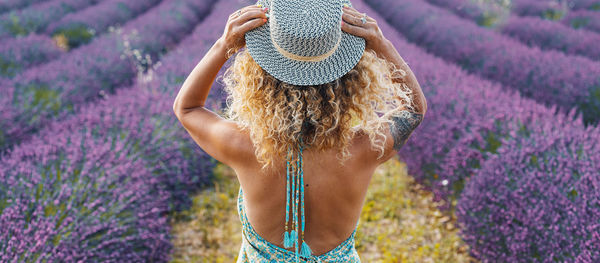 Rear view of woman standing on field