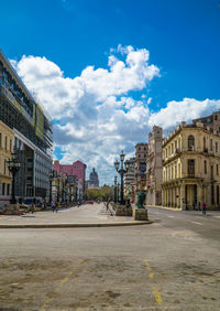 Street amidst buildings in town against sky