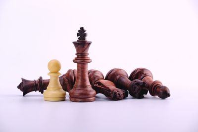 Close-up of chess pieces against white background