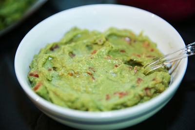 Freshly made guacamole in an isolated white bowl