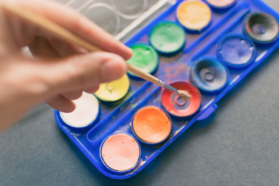 Close-up of hand holding paintbrush