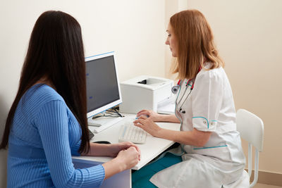 Doctor having discussion with patient in hospital