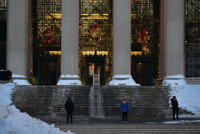 People walking on steps of temple