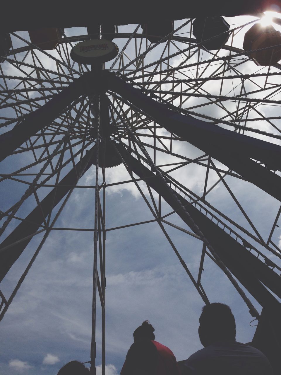 low angle view, sky, lighting equipment, silhouette, built structure, illuminated, street light, electricity, architecture, cloud - sky, technology, power line, indoors, dusk, ceiling, arts culture and entertainment, amusement park, no people, night