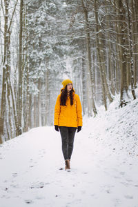Woman standing on snow covered land