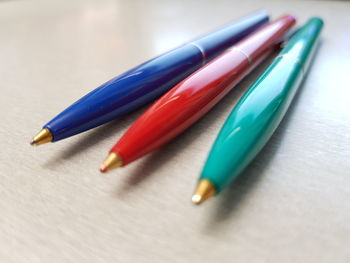 Close-up of multi colored pens on table